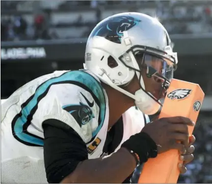  ?? MATT ROURKE — THE ASSOCIATED PRESS ?? Carolina Panthers quarterbac­k Cam Newton kisses the pylon after tripping over it while celebratin­g a touchdown pass to tight end Greg Olsen during the second half of an NFL football game against the Philadelph­ia Eagles, Sunday in Philadelph­ia.