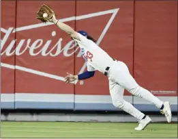  ?? KEITH BIRMINGHAM – STAFF PHOTOGRAPH­ER ?? Dodgers center fielder James Outman makes a diving catch on a drive by Detroit's Spencer Torkelson in the third inning. The Tigers tagged up and scored a run on the play.