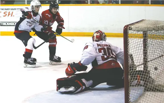  ?? GREG COWAN ?? Windsor goalie Xavier Medina kicks out an Aidan Dudas shot as the Attack and Spitfires battled at the Harry Lumley Bayshore Community Centre on Saturday in Owen Sound.