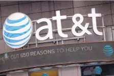  ?? MARK LENNIHAN/ASSOCIATED PRESS ?? The merger of AT&T, whose logo is seen above a retail shop in New York, with Time Warner, subject of the biggest antitrust trial in years, could affect how much consumers pay for streaming TV and movies.