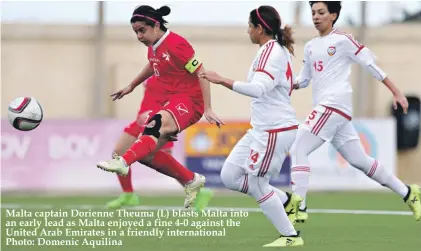  ??  ?? Malta captain Dorienne Theuma (L) blasts Malta into an early lead as Malta enjoyed a fine 4-0 against the United Arab Emirates in a friendly internatio­nal Photo: Domenic Aquilina