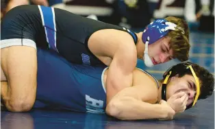  ?? RICK KINTZEL/THE MORNING CALL ?? Quakertown’s Mason Ziegler, top, won in overtime over a familiar foe to reach the 121-pound semifinals at Escape the Rock. He is joined by teammates Collin Gaj (145) and Calvin Lachman (215).