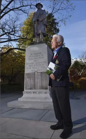  ?? PHOTOGRAPH BY JOHN RENNISON, THE HAMILTON SPECTATOR ?? Ed Keenleysid­e stands beside the Burlington cenotaph. A retired high school history teacher, he wrote the book, “We Were Just Doing Our Bit,” that tells the stories of all 82 people on the Burlington cenotaph.