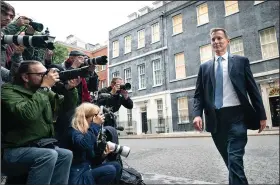  ?? (AP/PA/Stefan Roussea) ?? Jeremy Hunt, shown leaving 10 Downing Street in London on Friday after he was appointed Britain’s treasury chief, says Prime Minister Liz Truss’ new economic policies will “get the country growing.”