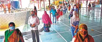  ?? AFP ?? Hindu devotees wait in line to offer prayers at the Alopidevi temple in Prayagraj yesterday.
■