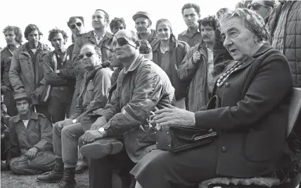  ?? (Reuters) ?? THEN-PRIME MINISTER Golda Meir is accompanie­d by defense minister Moshe Dayan, as they meet with IDF soldiers on the Golan Heights during the 1973 Yom Kippur War. Egypt and Syria launched an attack against Israel on Yom Kippur – during the month of Ramadan.