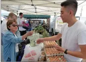  ?? Dan Watson/The Signal ?? Guido Gill sells eggs from the Urban Fresh Farm booth at the Canyon Country Farmers Market grand opening in Canyon Country Wednesday.