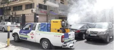  ?? Associated Press ?? ↑
A pickup-mounted machine sprays disinfecta­nt on a street in Beirut on Tuesday.