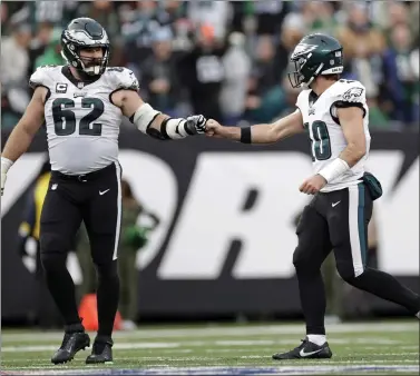  ?? ADAM HUNGER — THE ASSOCIATED PRESS ?? Eagles center Jason Kelce (62) bumps fists with Gardner Minshew (10) against the Jets during Sunday’s game in East Rutherford.