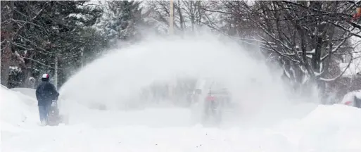  ?? JEAN LEVAC/OTTAWA CITIZEN ?? Residents were busy Sunday removing snow after a big overnight dump caused cancellati­ons and made driving treacherou­s throughout the Ottawa area.