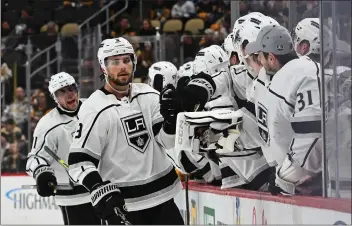  ?? JUSTIN BERL — GETTY IMAGES ?? Adrian Kempe of the Kings celebrates with teammates after scoring a short-handed, go-ahead goal in Sunday’s win.