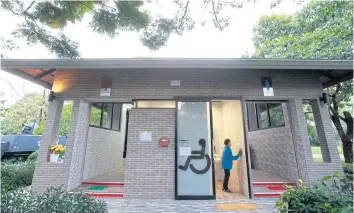  ??  ?? A MUST VISIT: A woman cleans a public toilet in Wachiraben­chathat Park (Suan Rot Fai Park) in Bangkok. Last year, the facility was named the most outstandin­g public park toilet by the Department of Health for its cleanlines­s and disabled-friendly facilities.