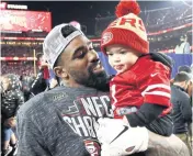  ?? AFP ?? San Francisco’s Raheem Mostert celebrates with his son Gunnar after the 49ers beat Green Bay.