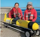  ?? DAVE ALLEN/NIWA ?? Niwa scientists Joe O’Callaghan, left, and Fiona Elliott launch a glider off Queen Charlotte Sound.