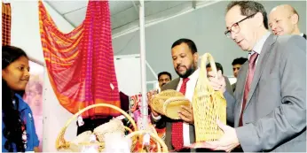  ??  ?? EU Ambassador to Sri Lanka Tung-laï Margue (right) and Minister Rishad Bathiudeen (centre) inspect handicraft­s displayed by a Northern SME at the SME trade fair