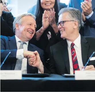  ?? DARRYL DYCK ?? Shell Integrated Gas and New Energies director Maarten Wetselaar, left, and LNG Canada CEO Andy Calitz shake hands after signing a final investment declaratio­n to build the LNG Canada export facility in B.C.