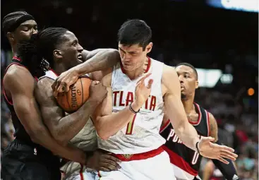  ?? — Reuters ?? I got it: Atlanta Hawks’ Taurean Prince (second from left) grabs a rebound against Portland Trail Blazers’ Noah Vonleh (left) in the NBA game in Atlanta on Saturday.