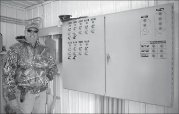  ?? Donnis Hueftle-Bullock ?? Above, Don Cantrell stands next to some of control panels for the grain drying system at his farm near Merna.