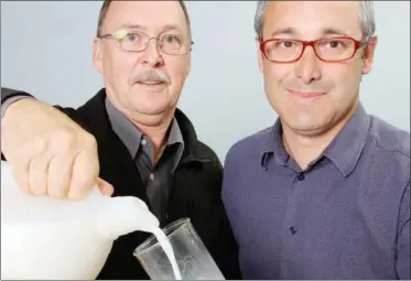  ??  ?? Andrew Offord, left, and Dennis Atkinson demonstrat­e one of their newly invented milk spouts.