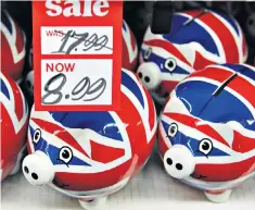  ??  ?? ‘I’m afraid there is no money’: thoroughly British piggy banks on sale in Oxford Street