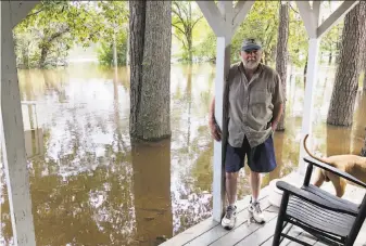  ?? Jeffrey S. Collins / Associated Press ?? Pastor Willie Lowrimore placed sandbags and plastic sheets around his church on the banks of the Waccamaw in Yauhannah, S.C. Water, however, seeped over the barriers.