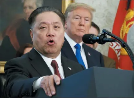  ?? EVAN VUCCI — THE ASSOCIATED PRESS FILE ?? Broadcom CEO Hock Tan speaks while U.S. President Donald Trump listens, in background, during an event at the White House in Washington, to announce the company is moving its global headquarte­rs to the United States. In a decision announced Monday,...