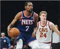  ?? (AP/Bebeto Matthews) ?? Brooklyn Nets forward Kevin Durant (left) drives to the basket Friday in a game against the Cleveland Cavaliers. Brooklyn is 3-1 against Cleveland this season and the two teams meet today to kick off the NBA play-in tournament.