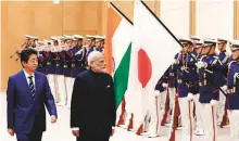  ?? AP ?? Japan’s Prime Minister Abe (left), escorts Prime Minister Modi while reviewing an honour guard ahead of a meeting at Abe’s official residence in Tokyo yesterday.