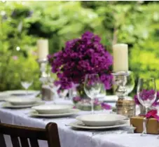  ?? ISTOCK ?? Use neutral tones such as black, brown, grey, white or cream with bold coloured accessorie­s when table setting for an outdoor dinner party.