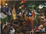  ?? — AFP ?? Children wave flags during a protest near the Prime Minister’s office in Amman, Jordan.