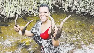  ?? Supplied) (Pic: ?? Zodwa Wabantu in a stream wrapped in traditiona­l healer clothes.