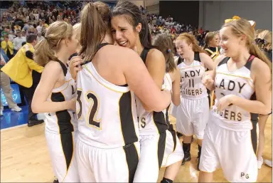  ?? FILE PHOTO ARKANSAS DEMOCRAT-GAZETTE ?? Prairie Grove’s Julie Rutherford (facing) celebrates with teammate Alex Myers (No. 32) in their 59-56 victory over Star City in the class 4A girls state championsh­ip held Thursday, March 11, 2010 at the Summit Arena in Hot Springs. That championsh­ip season is the top story of the Decade: 2010-2019 for Prairie Grove as selected by the Enterprise-Leader.