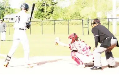  ??  ?? East Webster catcher Gavin Edwards (22) secures a pitch into his glove during Saturday’s game against Oak Hill Academy. (Photo by Mattilyn Thornton, for Starkville Daily News)