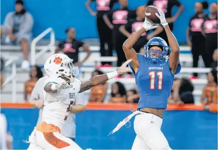  ?? REINHOLD MATAY/ORLANDO SENTINEL ?? West Orange receiver Darrell Harding Jr., catching a touchdown pass against Jones defender Dominik Hill earlier this season, set school singlegame receiving records for yards (235) and TD catches (4) in a 61-13 win against Ocoee last week.10. Harmony(9-1):14. (16) Dr. Phillips (5-5):