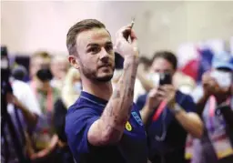  ?? (Reuters)* ?? England’s James Maddison plays darts at the Al Wakrah Stadium yesterday.