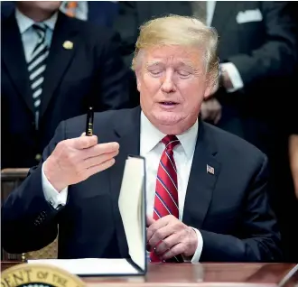  ??  ?? U.S. President Donald Trump prepares to sign an Executive Order establishi­ng the White House Opportunit­y and Revitaliza­tion Council during an event in the Roosevelt Room at the White House in Washington, U.S., December 12, 2018. REUTERS/Jonathan Ernst