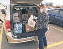  ?? CONTRIBUTE­D ?? P.E.I.’s Gifts from the Heart founder and chief executive officer Betty Begg masks up when heading to pick up supplies for low income families and others who may need help.