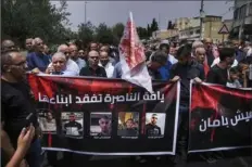  ?? Associated Press ?? Protesters march June 8 against mounting violence before the funeral of two of the five Palestinia­n citizens of Israel who were killed when a gunman opened fire at a car wash in Yafa an-Naseriyye, near the city of Nazareth, Israel.