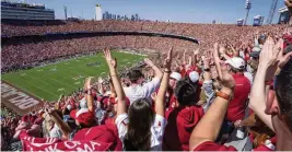  ?? JEFFREY MCWHORTER / AP ?? Oklahoma fans celebrate a touchdown during the first half of an NCAA college football game against Texas at the Cotton Bowl in Dallas on Oct. 7, 2023. The ESPN “College Gameday” analyst Kirk Herbstreit and broadcaste­r Chris Fowler announced Feb. 22 they will be voices in EA Sports’ college football video game.