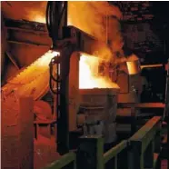  ??  ?? Top to bottom: A worker checks the melted metal after it has been transferre­d from the furnace to the molding machines at the Waupaca Foundry; Scrap metal used in the casting process is seen at the foundry; Melted scrap metal is transferre­d from the...