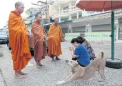  ??  ?? PRAYER OFFERING: Buddhist monks offer a prayer for devotees after a morning alms collection in Sungai Kolok district of Narathiwat. Projects are being promoted to spur growth of the provinces in the far South.