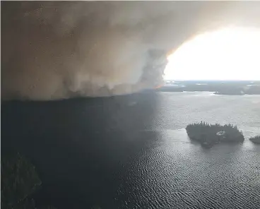  ??  ?? All 2,000 residents of Wasagamack First Nation had to evacuate as a forest fire came within 800 metres of the Manitoba community. Smoke also forced out people from the St. Theresa Point and Garden Hill reserves.