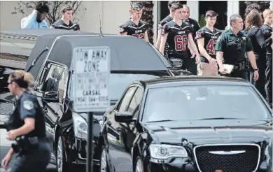  ?? JOE RAEDLE GETTY IMAGES ?? Mourners leave after the Thursday funeral of Aaron Feis who was the football coach at Marjory Stoneman Douglas High School.