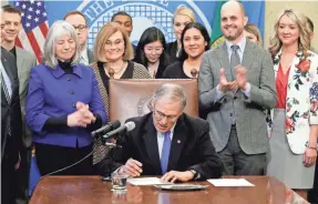  ?? TED S. WARREN/AP ?? Washington Gov. Jay Inslee signed a bill March 5 to protect the open Internet. The action there and in other states suggests Net neutrality could be an issue in the midterm elections and even the 2020 presidenti­al election.