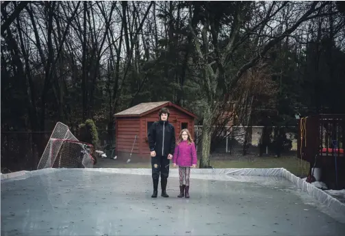  ?? AARON VINCENT ELKAIM NEW YORK TIMES ?? Jack Williams, 12, and his sister Cara, 8, in their family’s melting ice rink in Waterloo. Homemade backyard rinks used to offer good skating in this part of Canada from early December into March; the tradition, deeply embedded in Canada’s national...