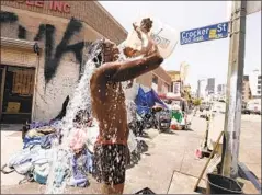  ?? Genaro Molina Los Angeles Times ?? GOV. GAVIN NEWSOM is demanding local leaders do more to get people off the streets. Above, Dennis Johnson washes himself on skid row.