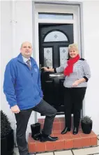  ??  ?? New door Grant Allen of Tom Callaghan Windows with delighted customer Agnes Dawe of Ayr outside her new front door