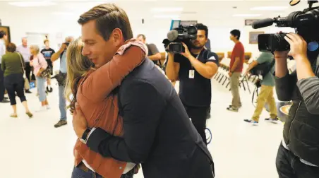  ?? Carlos Avila Gonzalez / The Chronicle ?? California Rep. Eric Swalwell hugs supporter Emily Goodman after announcing the end of his Democratic White House bid.