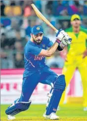  ??  ?? Virat Kohli drives during the third and final ODI against Australia at ■ the M Chinnaswam­y Stadium in Bengaluru on Sunday.