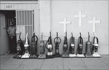  ?? Photograph­s by Luis Sinco Los Angeles Times ?? A VACUUM repair shop and a church share space. “The fact that we keep changing the name of South-Central/South L.A. really points to the fact that we haven’t done enough to make it a different place,” a critic said.
